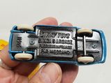 a person holding a small toy car in their hand