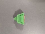 a small green object on the floor of a kitchen