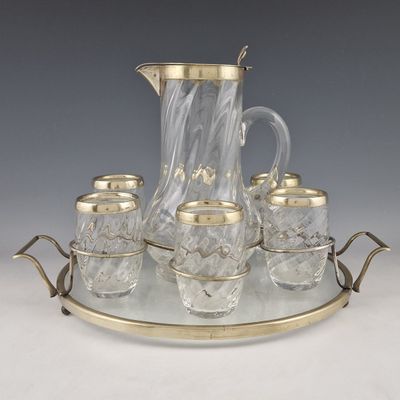 an image of a glass and brass tea set on a tray