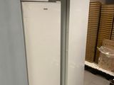two white refrigerators and a microwave sitting on top of each other