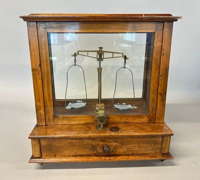 an old wooden case with a scale on top of it