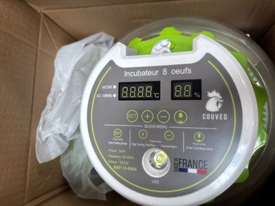 a box with a green and white electronic device inside of it