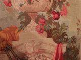 a painting on the wall of a room with a vase of flowers on it