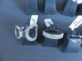 many different types of rings on display in a display case