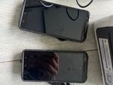 three cell phones sitting on a table next to a printer