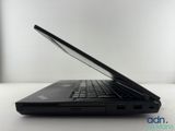 the laptop is open on a white table with a black keyboard