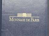 a close up of a blue book with a white building in the background