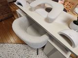 a table with a toilet seat and a vase of flowers on it