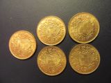 four gold coins sitting on top of each other on a table