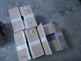 many cardboard boxes stacked on top of each other on the floor