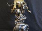bronze statue of a woman and a dog on a marble base
