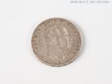 a silver coin on a white surface with a white background
