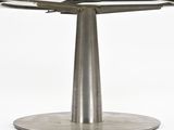an image of a round glass table with a metal base