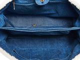 the inside of a blue purse with a white fur lining