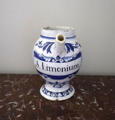a blue and white vase sitting on top of a table