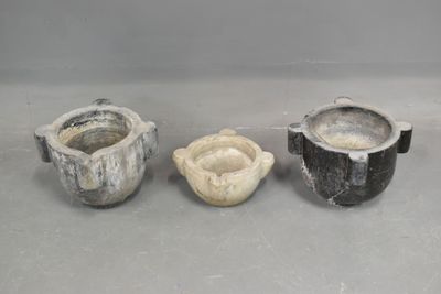 three different types of pottery sitting on a table