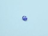 an oval blue sapphire stone sitting on top of a white surface