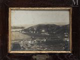 an old picture of a picture of a small town in the middle of a mountain