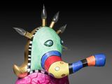 brightly colored sculpture of an elephant holding a ball with spikes on it ' s head