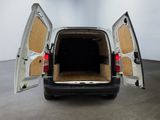 a white van with its doors open in a room