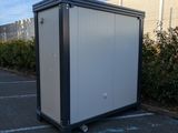 a portable toilet in the middle of a parking lot