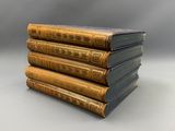 a stack of five books sitting on top of each other