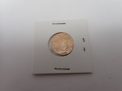 une image représentant une petite pièce de monnaie dans une boîte blanche