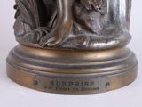 bronze statue of a woman with a dog on a pedestal