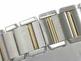 a close up of a silver and gold watch bracelet
