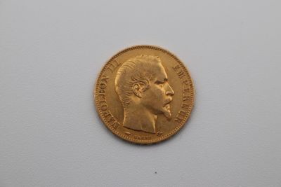 a close up of a gold coin on a white surface