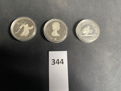 three british coins are shown next to each other on a table