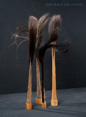 two wooden hair brushes sitting next to each other on a table