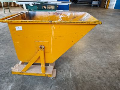 an image of a yellow dumpster sitting on top of a cement floor