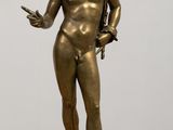 bronze statue of a male nude torsoed man holding a sword