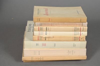 several books are stacked on top of each other on a table
