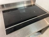 stainless steel stove top with two burners on it in a kitchen