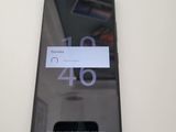 a close up of a cell phone on a white table