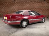 a red car that is parked in front of a brick wall