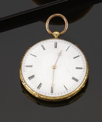 an antique gold pocket watch with roman numerals on the face