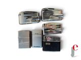 four lighters sitting next to each other on a white surface