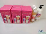 three boxes of soap and a bottle of lotion sitting on a table