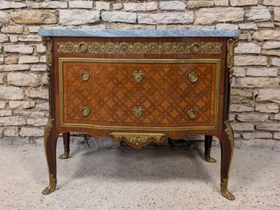 a marble top chest of drawers on a stand