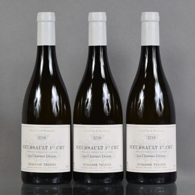 three bottles of wine sitting on top of a table next to each other