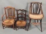 three wooden chairs and a chair with a cushion on top of them