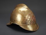 a close up of a gold helmet with a crest on it