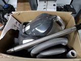 a box full of vacuum cleaners and other items in it