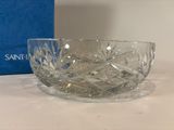 an image of a glass bowl sitting on a table next to a blue box