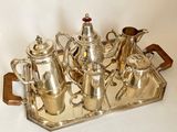 a silver tray with a silver tea set on it