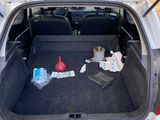 the back of a car with its trunk open and a lot of items in the trunk
