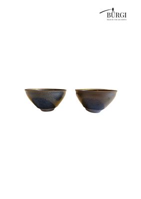 two bowls are sitting side by side on a white surface